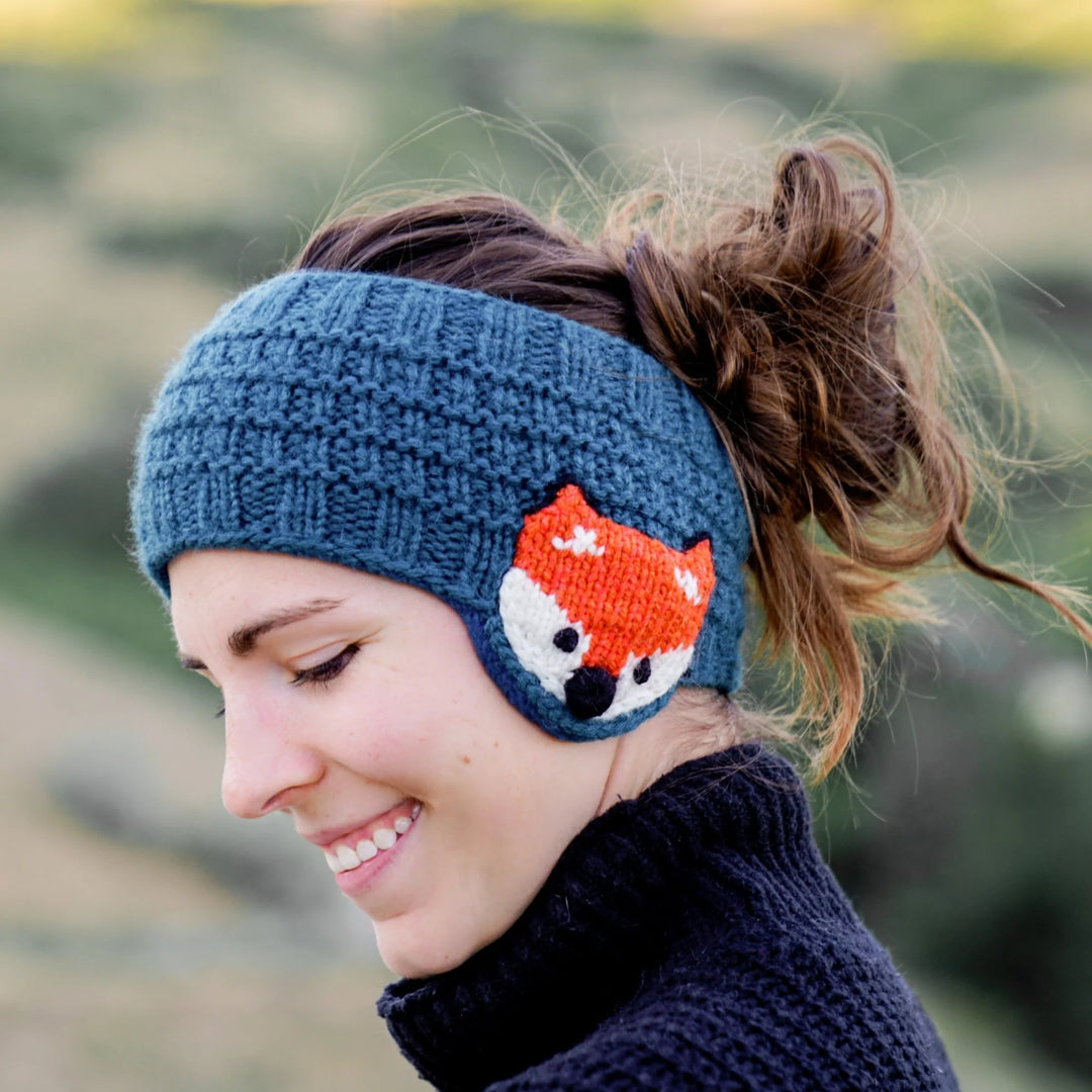 a woman wearing blue fox ear warmers