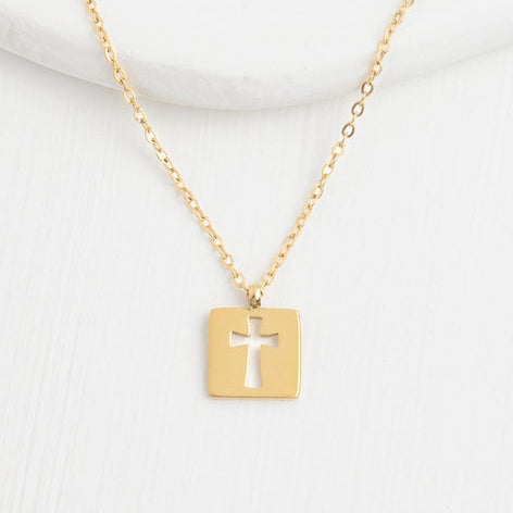 Gold necklace with a cross pendant on a white background