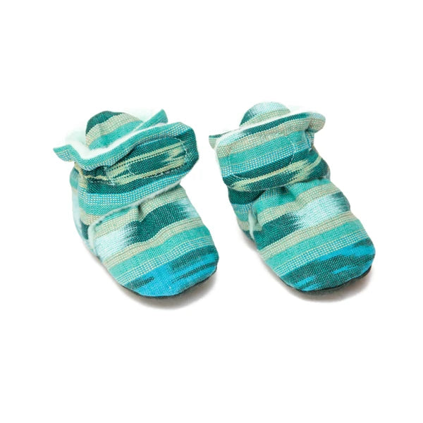 Pair of blue and green striped baby booties on a white background