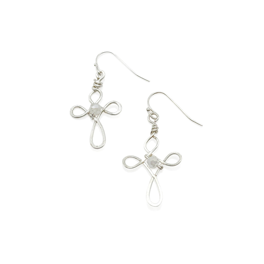 Pair of silver cross-shaped earrings on a white background