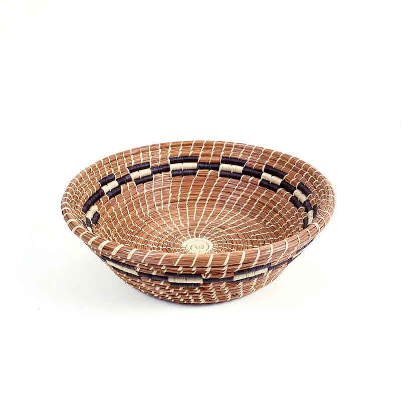 a pine needle basket on a white background