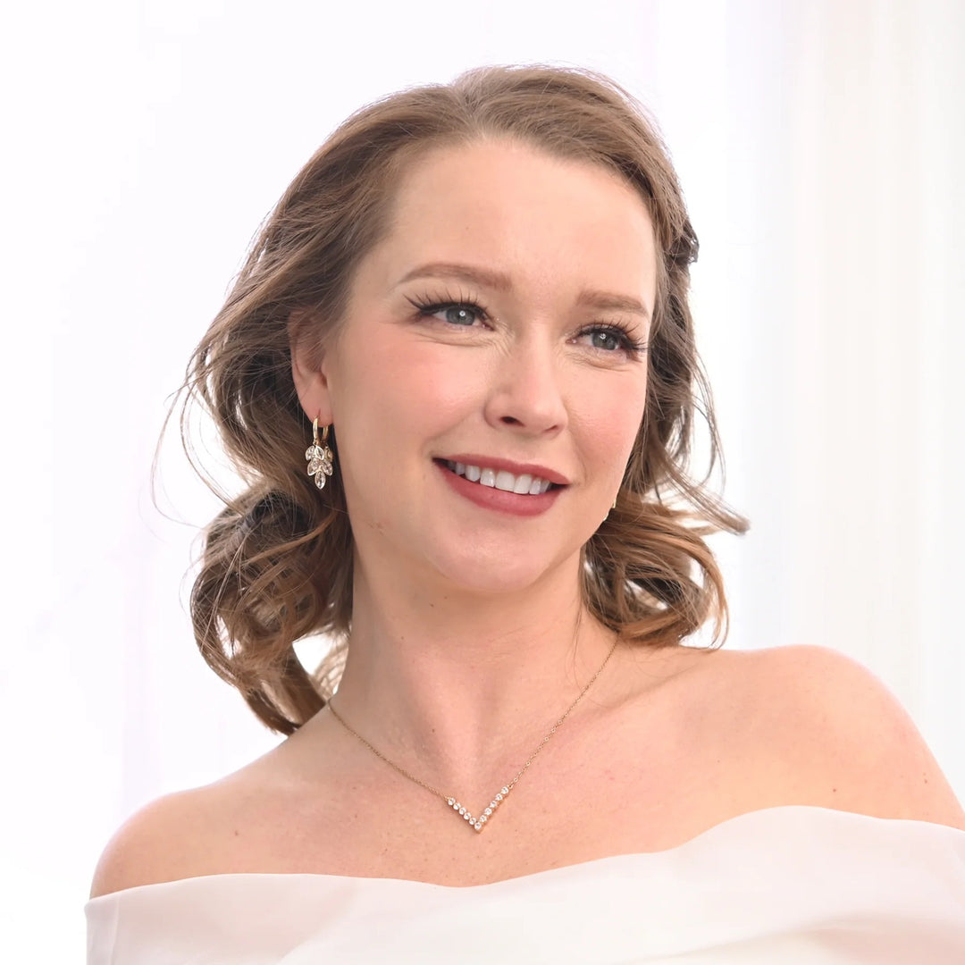 Woman wearing a white off-shoulder top with a plain background