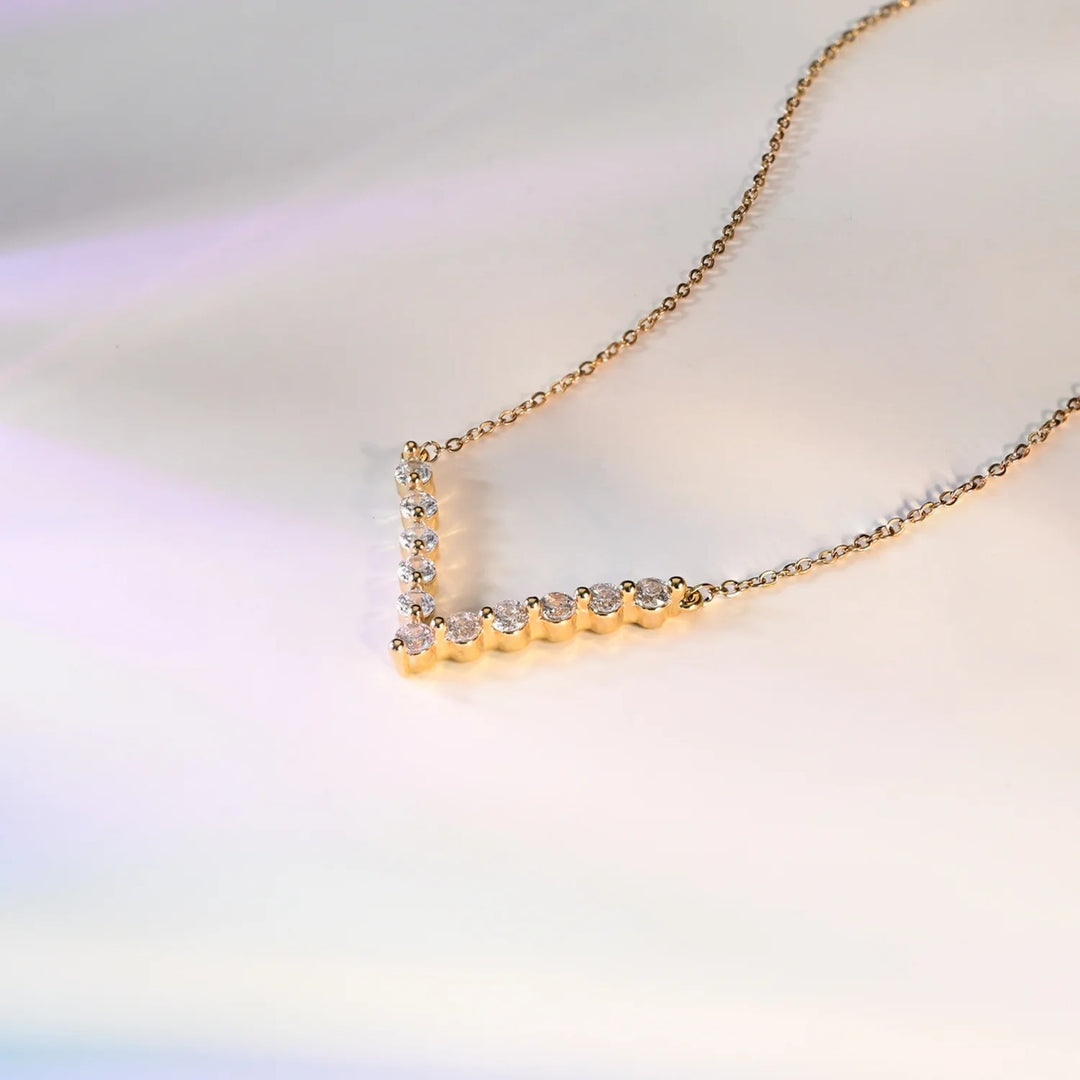 Gold necklace with small diamonds on a soft, blurred background