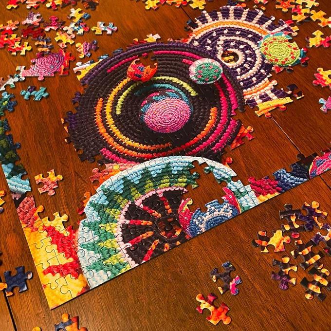 an unfinished puzzle on a wooden table 
