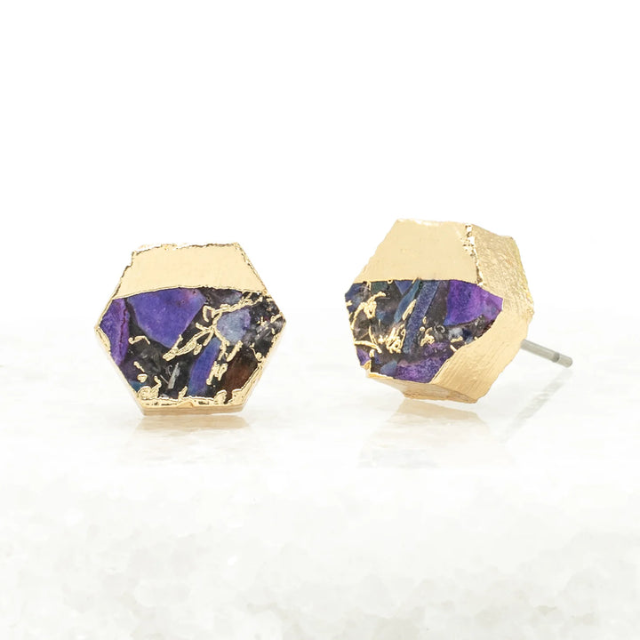 Gold and purple geometric earrings on a white background