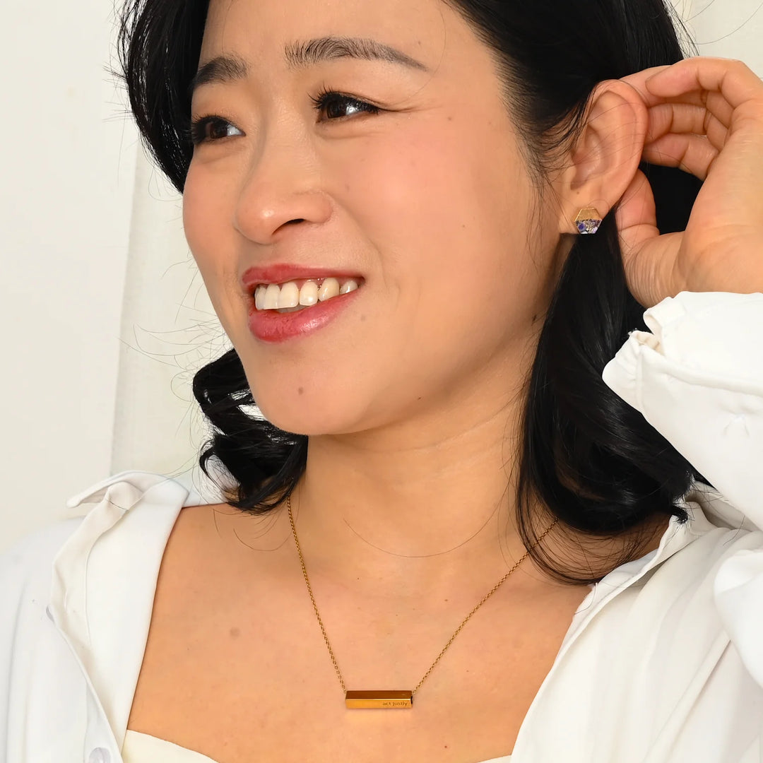 Woman adjusting her hair with a white background