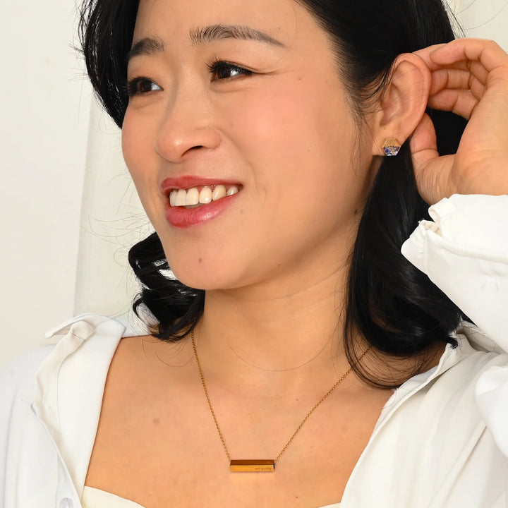 Woman adjusting her hair with a white background