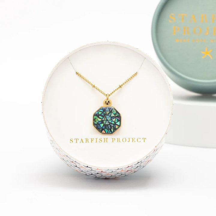 Necklace with a green pendant in a Starfish Project box on a white background
