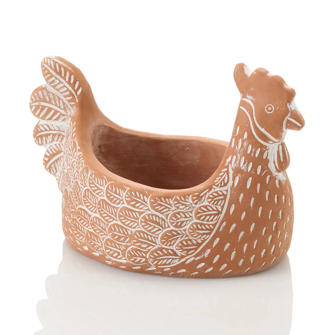 Ceramic chicken-shaped planter with white patterns on a white background