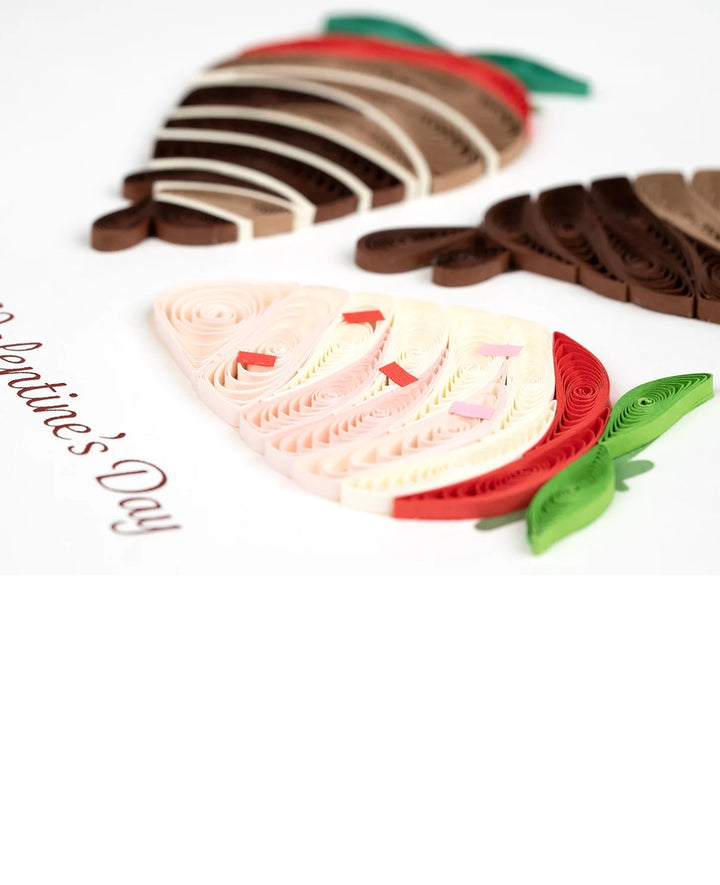Quilled Decorative strawberries with red, and white icing on a white background with 'Valentine's Day' text.