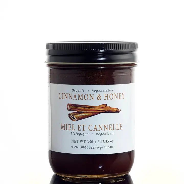 large jar of cinnamon honey on a white background