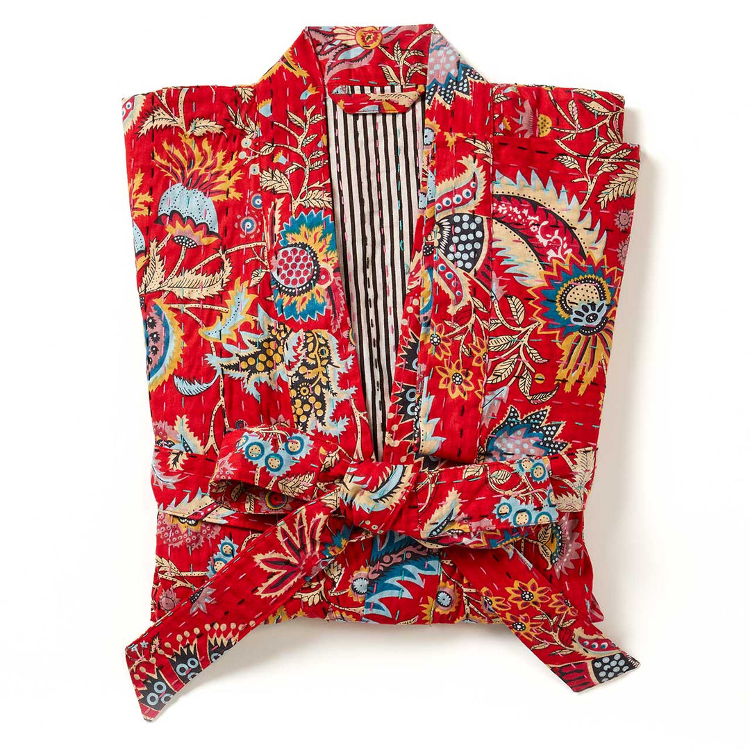 a folded crimson paisley kantha robe. 