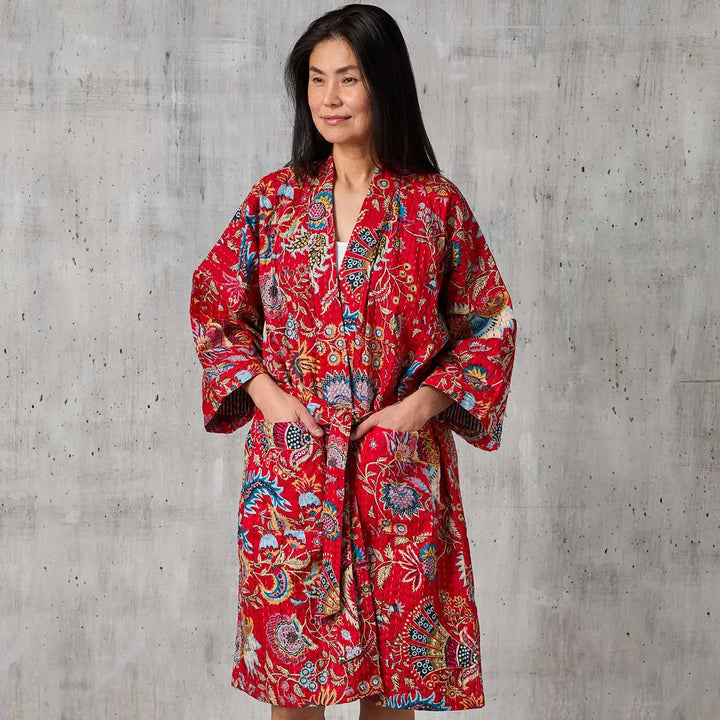 woman wearing a crimson paisley kantha robe