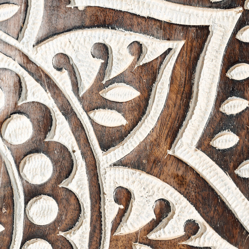 Close-up of intricate wooden inlay with white and brown patterns