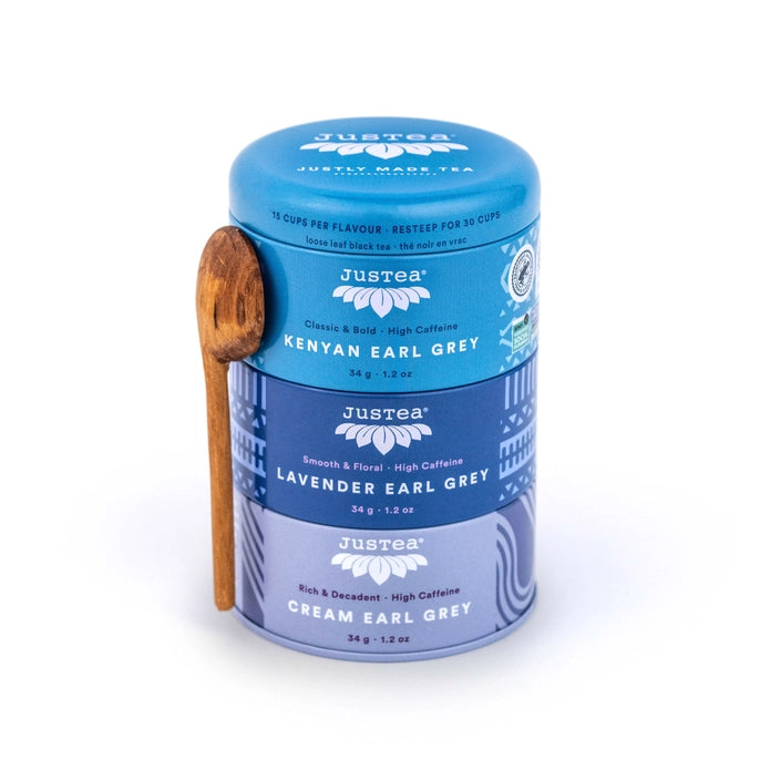 JusTea earl grey trio tin with wooden spoon on a white background