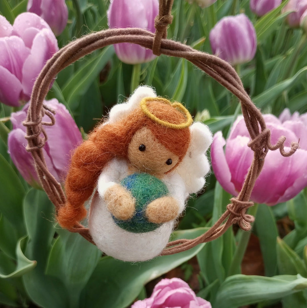 Earth angel ornament with a pink tulip background