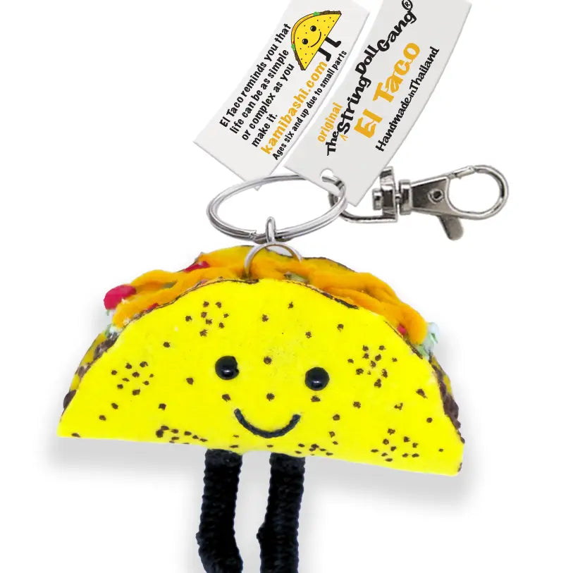 Taco-shaped keychain with a smiling face on a white background