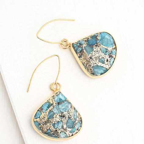 Pair of blue teardrop earrings with gold accents on a white background