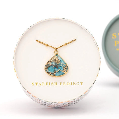 Necklace with a turquoise pendant in a 'Starfish Project' box on a white background