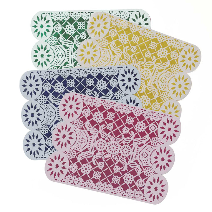 Set of colorful lace-style placemats on a white background