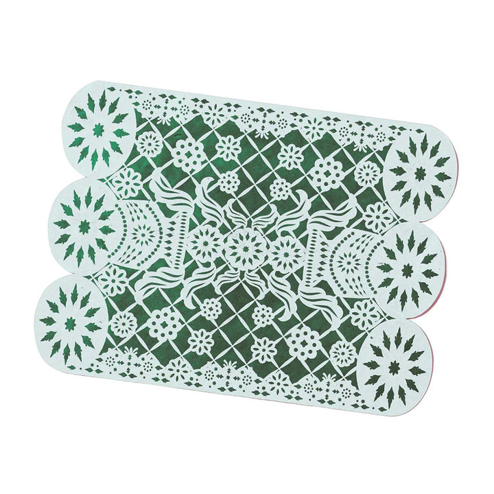 Green and white decorative placemat with floral and geometric patterns on a white background