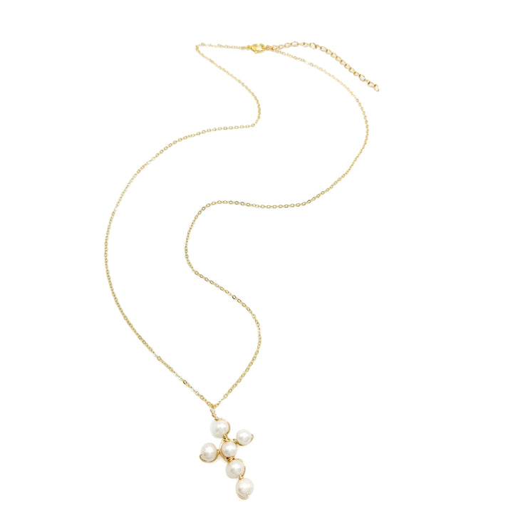 Pearl cross-shaped necklace on a gold chain