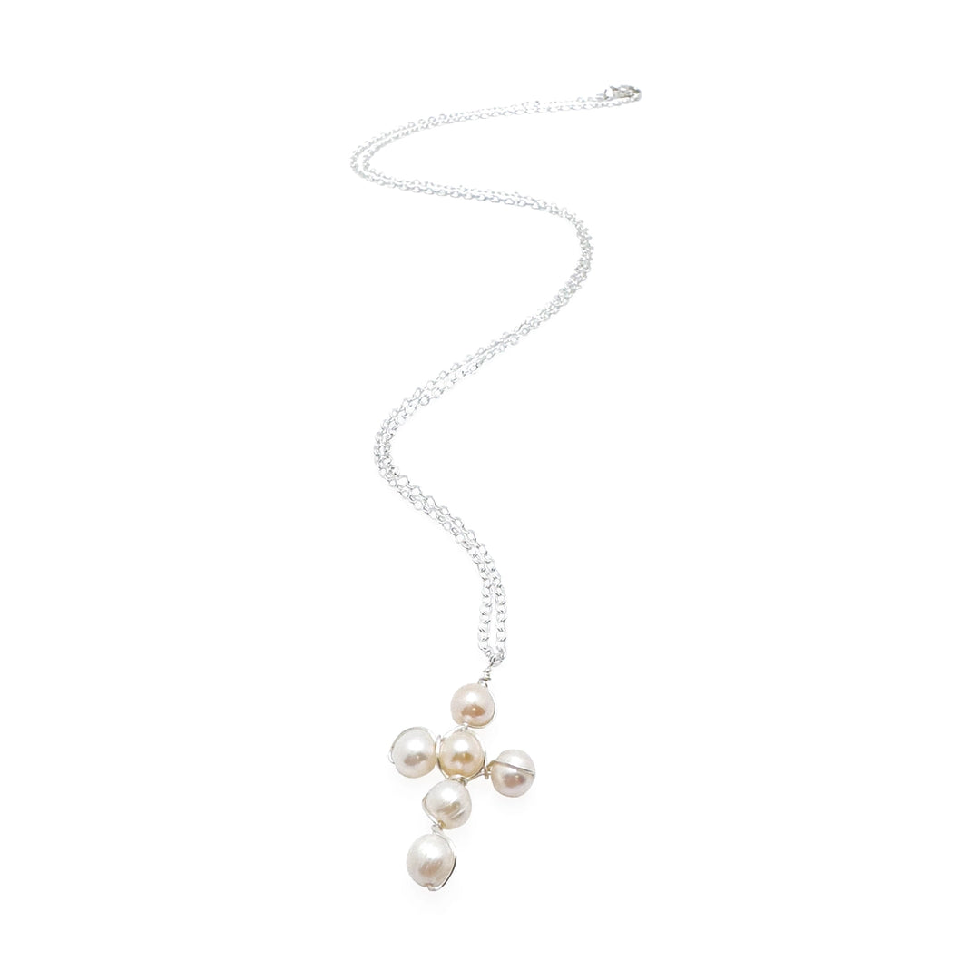 Pearl necklace on a silver chain with a cross pendant on a white background