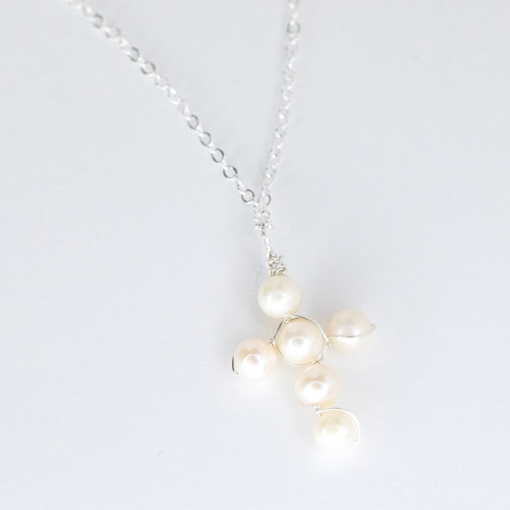 Pearl necklace with silver chain on a white background
