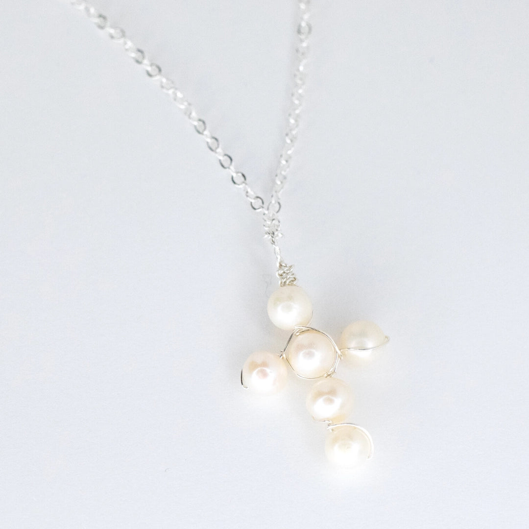 Pearl necklace with silver chain on a white background