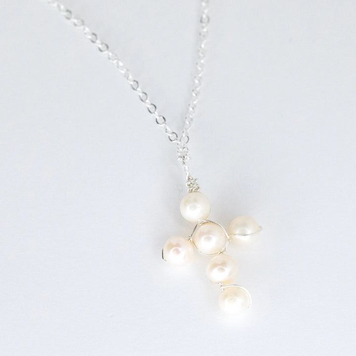 Pearl necklace with silver chain on a white background