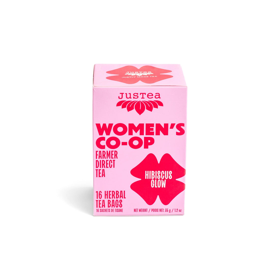 Pink box of Justea Women's Co-op Hiriscus Glow tea on a white background