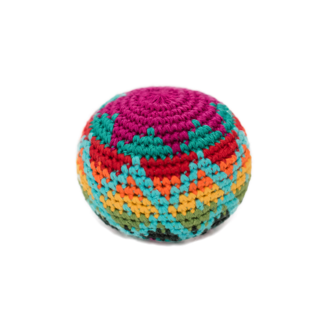 Multicolored crocheted hacky sack ball on a white background