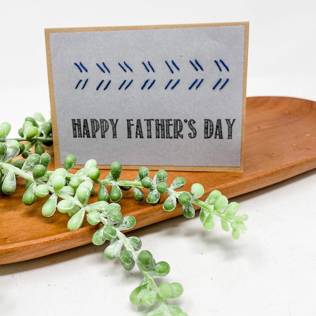 Father's Day card with greenery on a wooden board