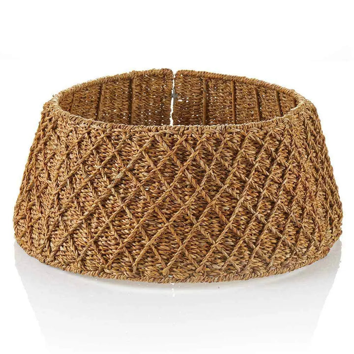 A wide woven tree collar made from natural brown raffia or straw, featuring a textured diamond-pattern weave, shown on a white surface.