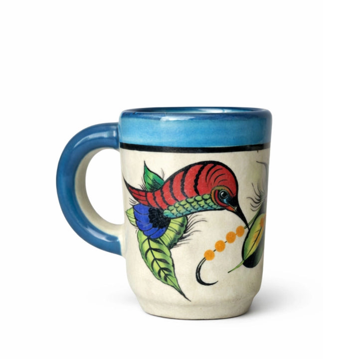 Ceramic mug with a colorful hummingbird  design on a white background