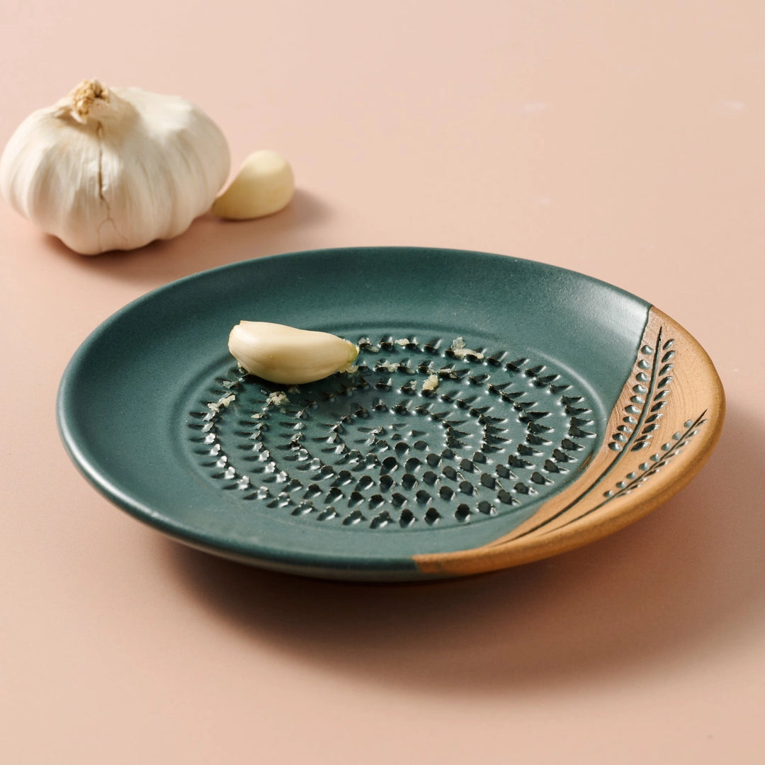 Ceramic grater dish with decorative edge on a beige background
