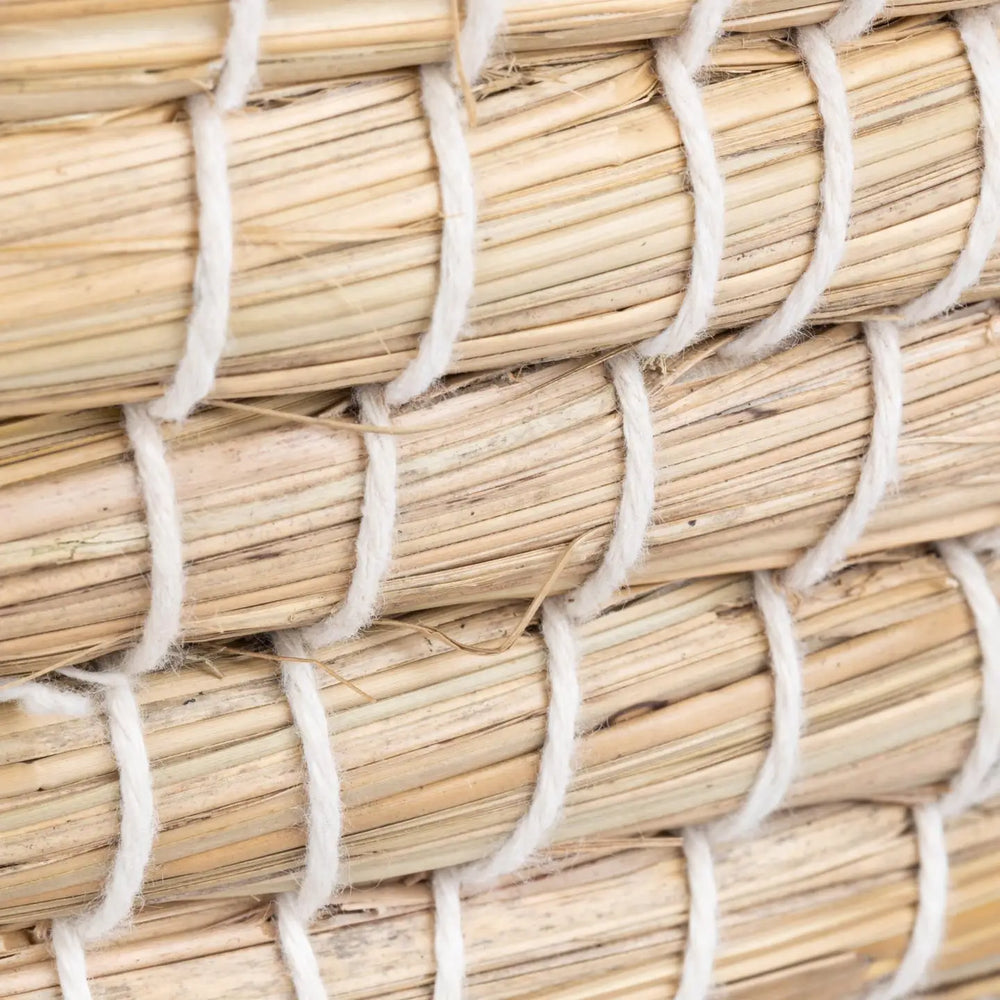 Close-up of woven straw basket with white fibers