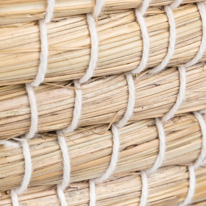 Close-up of woven straw basket with white fibers