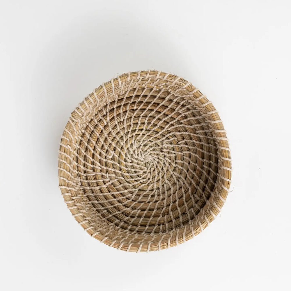 Round woven basket on a white background