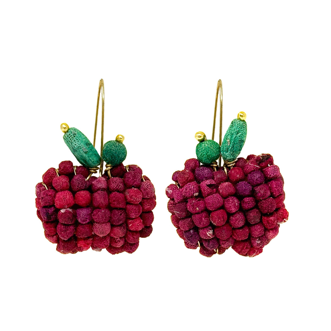 Pair of apple-shaped earrings with green leaves and gold hooks on a white background