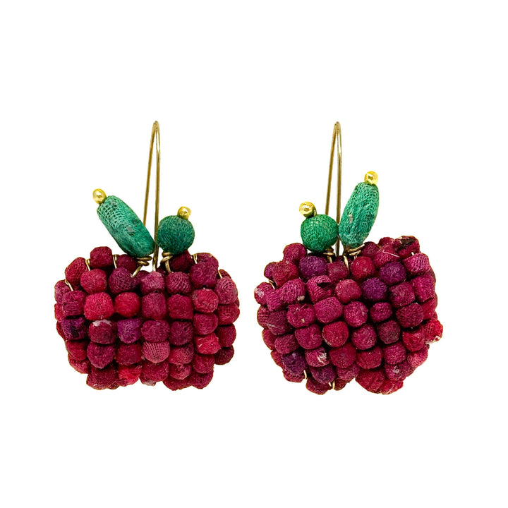 Pair of apple-shaped earrings with green leaves and gold hooks on a white background