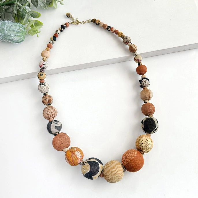 Kantha necklace with desertscape beads on a white background