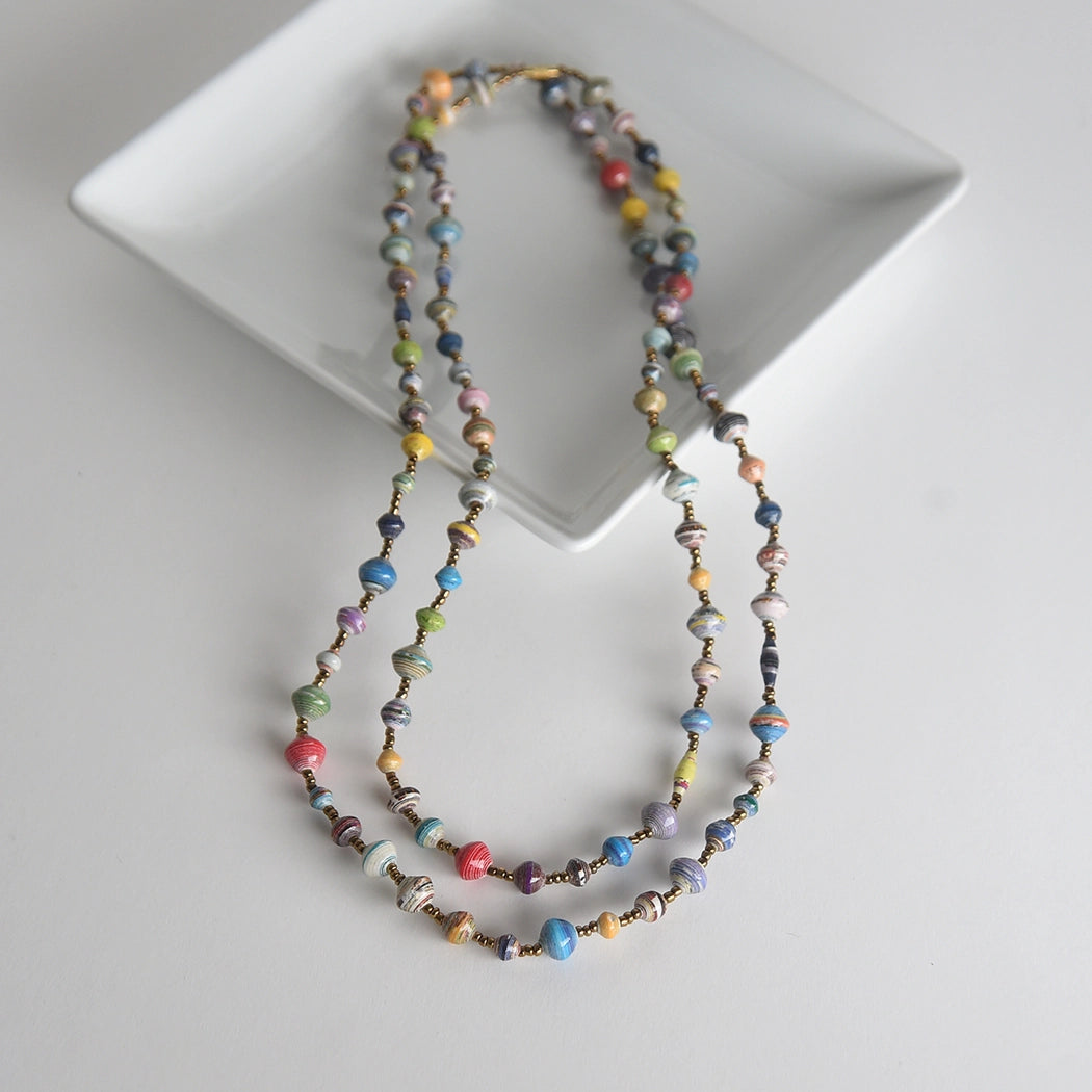 Multicolored beaded necklace on a white plate