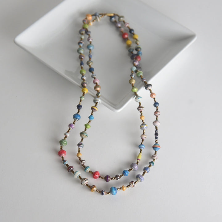 Multicolored beaded necklace on a white plate