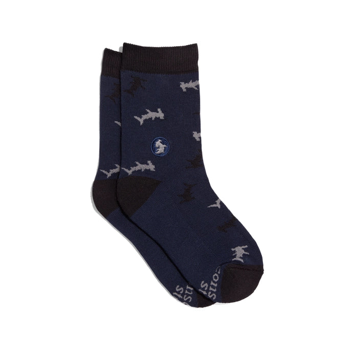Conscious Step navy crew sock with sharks on a white background. 