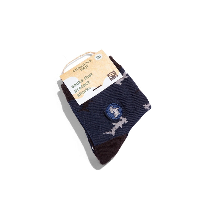 Conscious Step navy crew sock with sharks on a white background. 