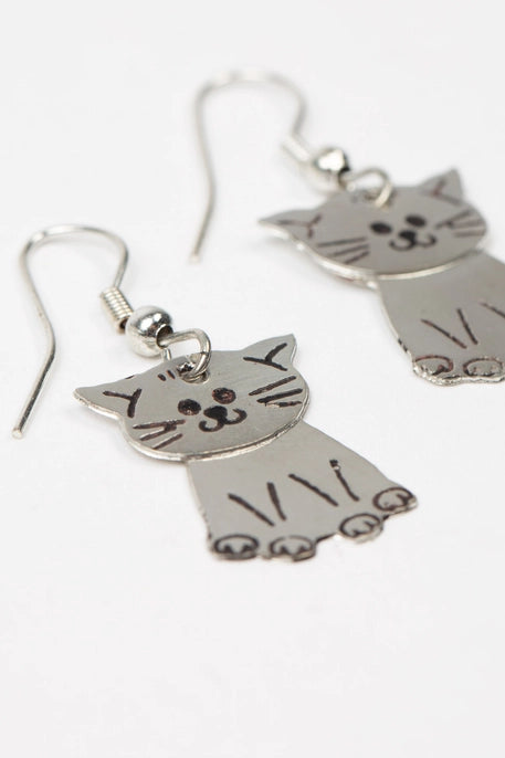 Cat-shaped earrings on a white background