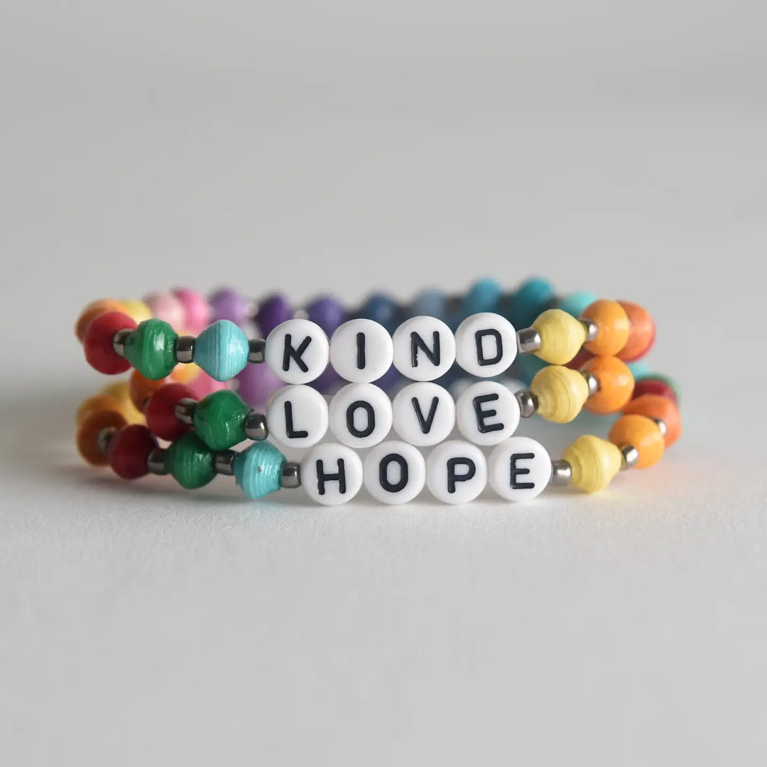 Colorful beaded bracelet with 'KIND LOVEHOPE' message on a light gray background
