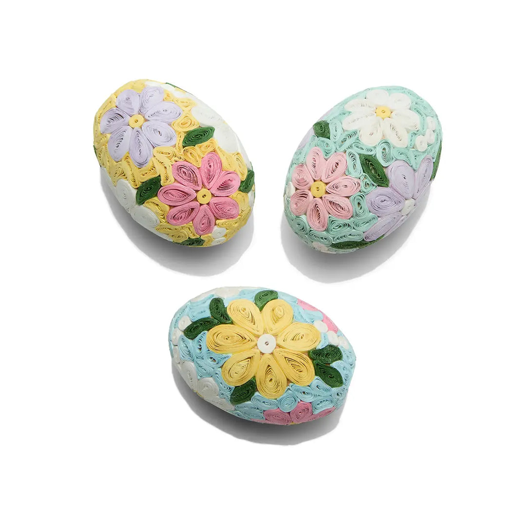 Three decorated Easter eggs with floral patterns on a white background