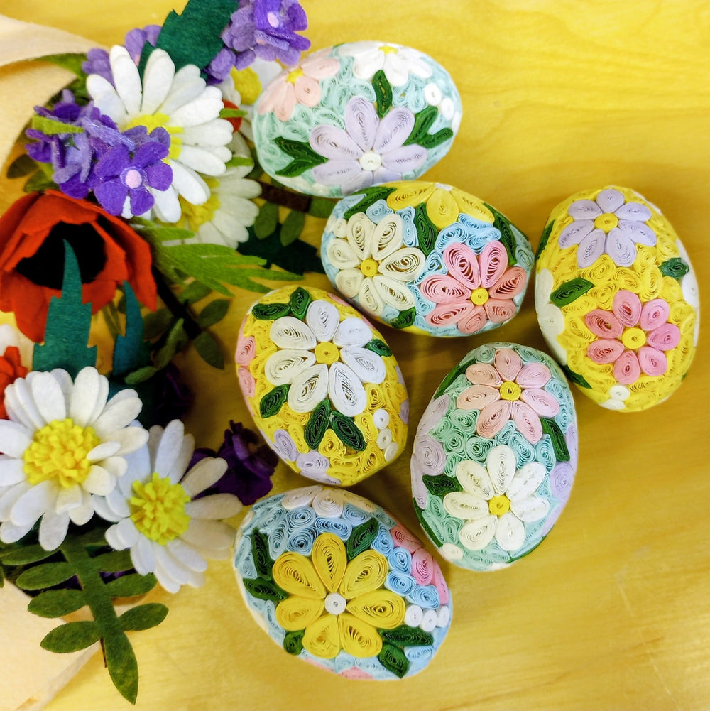 Decorative Easter eggs with floral designs on a yellow background